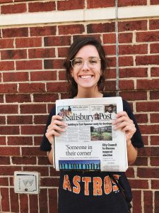 Natalie Alms holding the copy of the Salisbury Post in which her story on foster parenting appeared