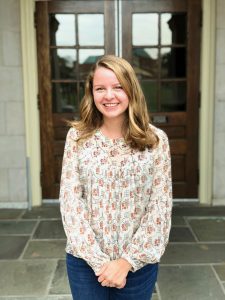A picture of Katherine Laws in front of a door